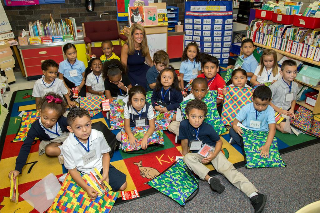 Freeholder Deputy Director Serena DiMaso presents sackpacks to kindergarten students at the Freehold Learning Center on Sept. 7 in Freehold, NJ.