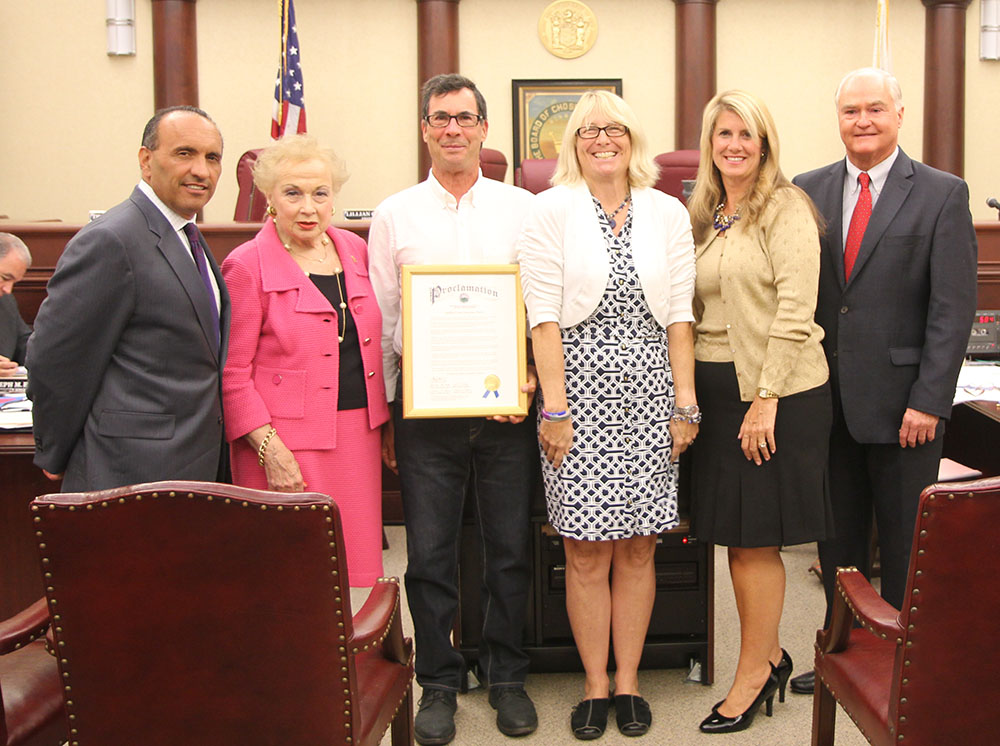 The Monmouth County Board of Chosen Freeholders present a proclamation for “Childhood Cancer Awareness Month” to The Kortney Rose Foundation Founder and President Kristen Gillette and her husband Rich, who lost their daughter Kortney to a brain tumor, at their regular public meeting on Sept. 10 in Freehold, NJ. Pictured left to right: Freeholder Thomas A. Arnone, Freeholder Lillian G. Burry, Rich and Kristen Gillette, Freeholder Deputy Director Serena DiMaso and Freeholder John P. Curley.