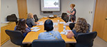 Clients in a conference room receive resume training