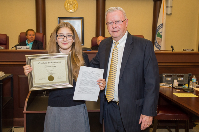 Third place history essay winner Victoria O’Leary, of at Oak Hill Academy in Lincroft, with Historical Commission board member Glenn Cashion.