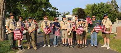 Boy Scouts of Oakhurst - Troop 71 and Troop leaders with Commissioner Kiley at Mount Carmel Cemetery holding flags