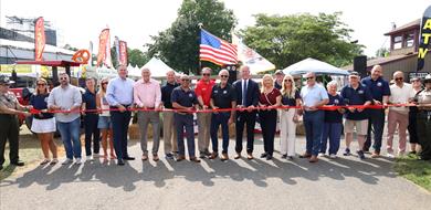 Elected Officials, Commissioner members and park staff in a group photo holding a ribbon