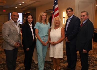 group photo of Director Arnone, Assemblywoman Donlon and others in attendance at the meeting