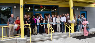 County Officials, Interfaith Neighbors, Center employees &amp;amp; community members getting ready to cut the ribbon to open the Dr. Lorenzo Harris Early Childhood Learning Center